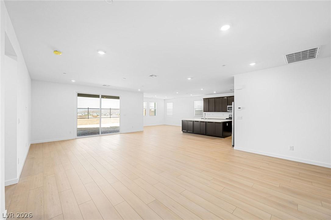Image 3: Blonde wood flooring flows seamlessly through this