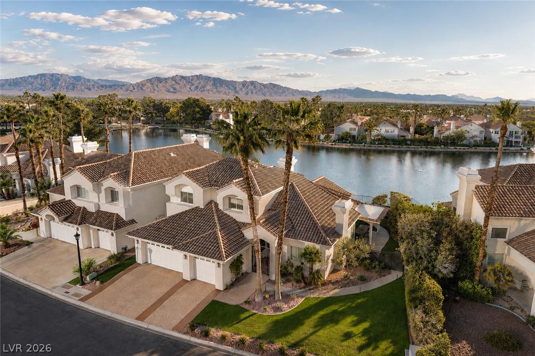 Image 2: Spanish-style homes line a picturesque lake, nestl