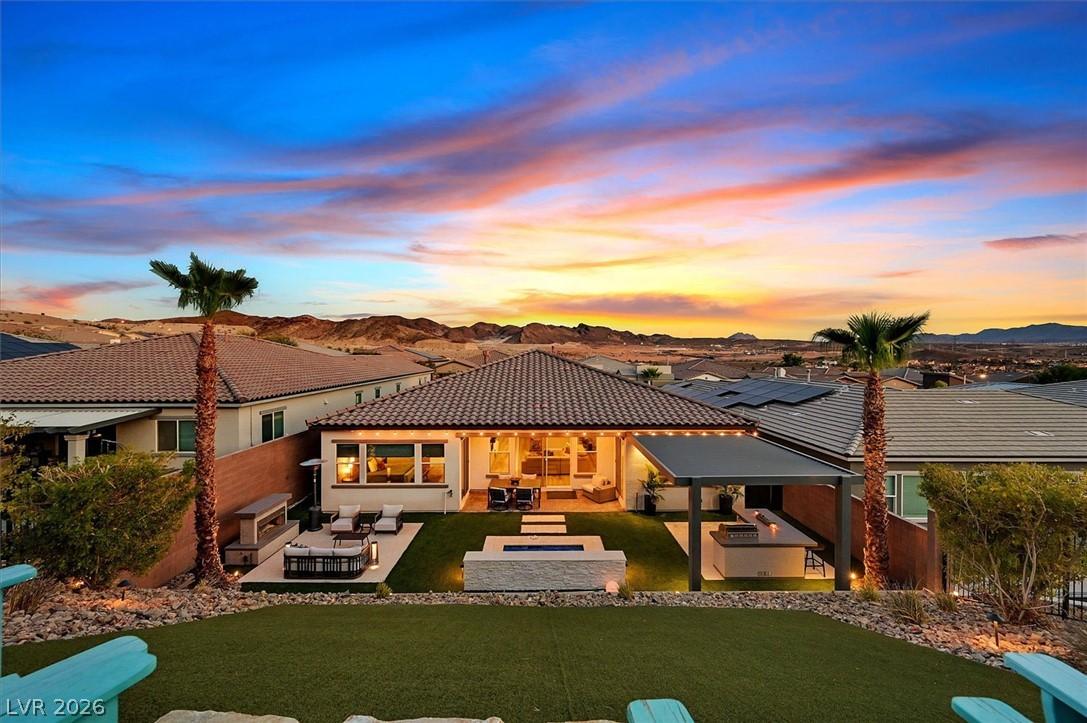 Image 2: A captivating sunset frames this residence, featur