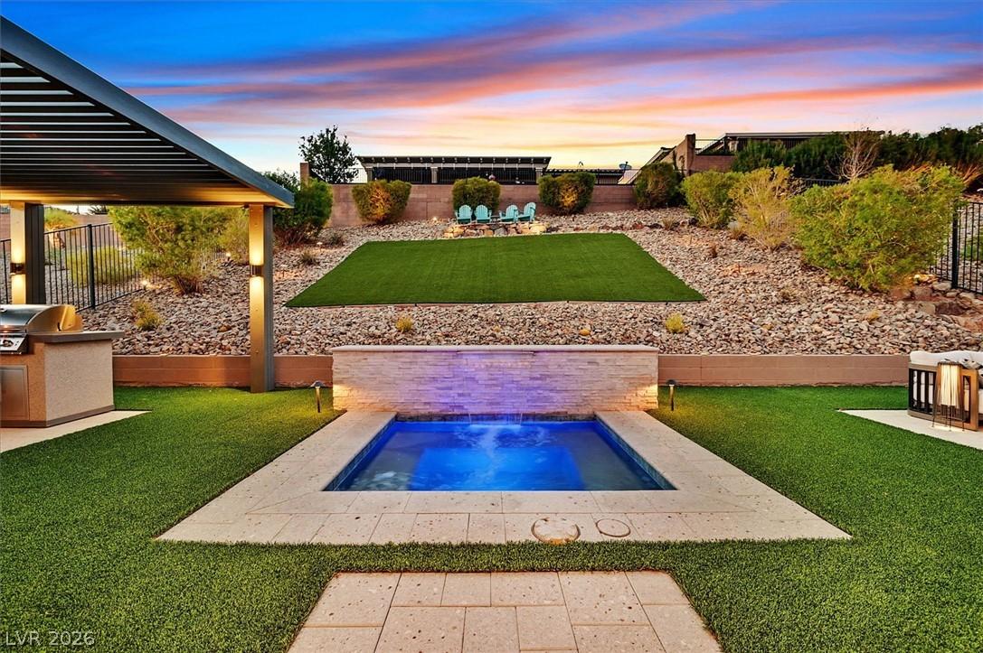 Image 3: An inviting outdoor oasis, with a built-in spa, ba