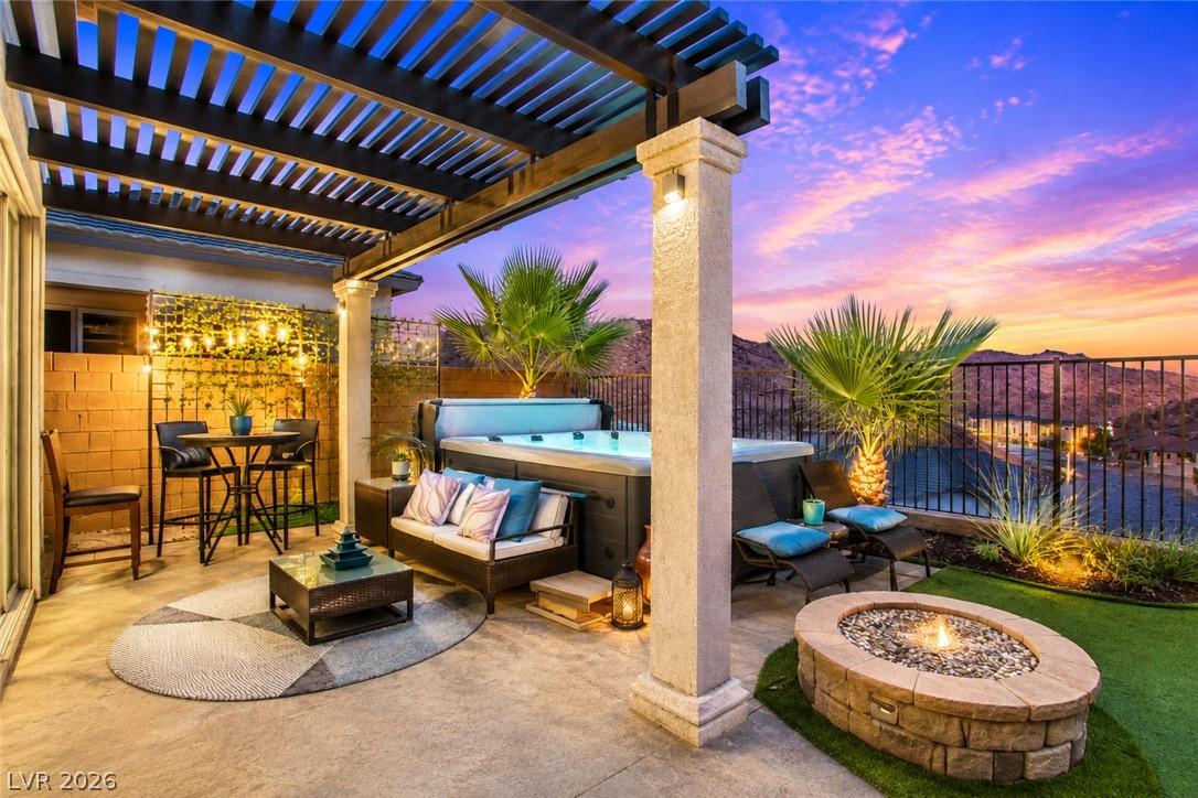 Image 4: An inviting patio oasis features a relaxing spa an