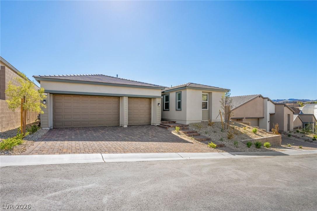 Image 2: A contemporary desert home with a spacious paver d