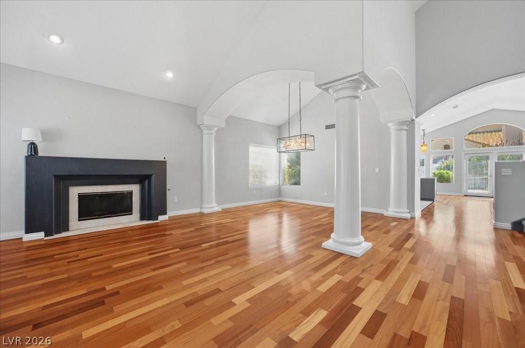 Image 4: This living area features a fireplace and polished