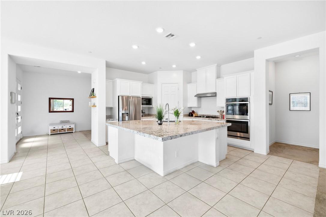 Image 4: A spacious kitchen with an inviting granite island