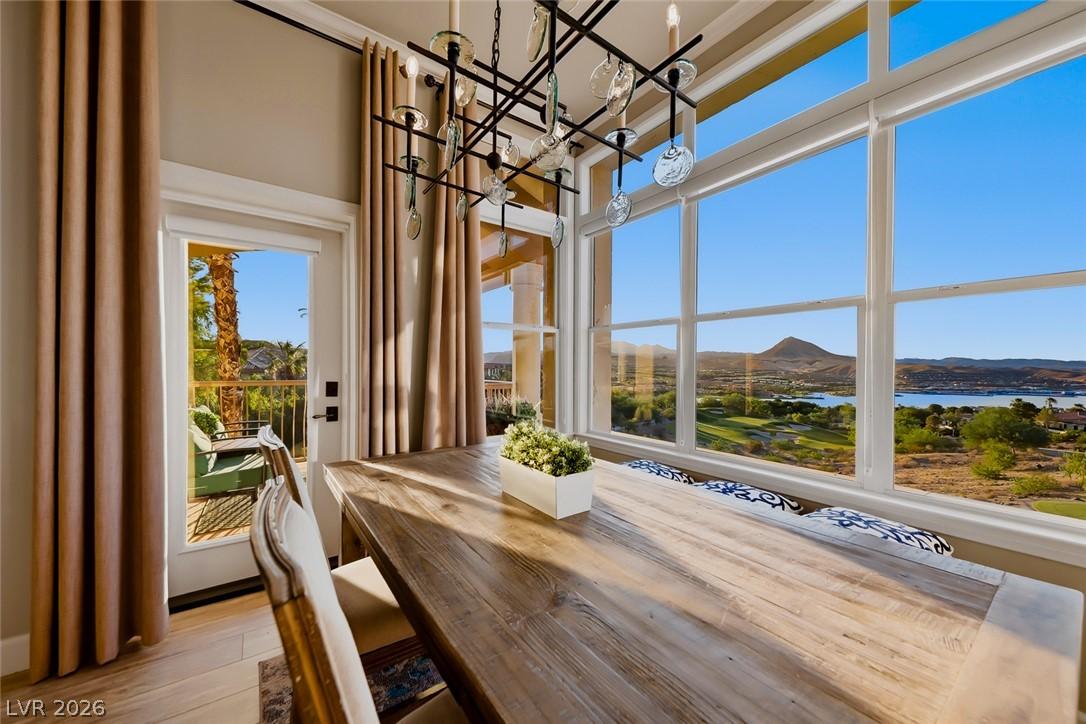 Image 1: Dining area with large windows frame picturesque l