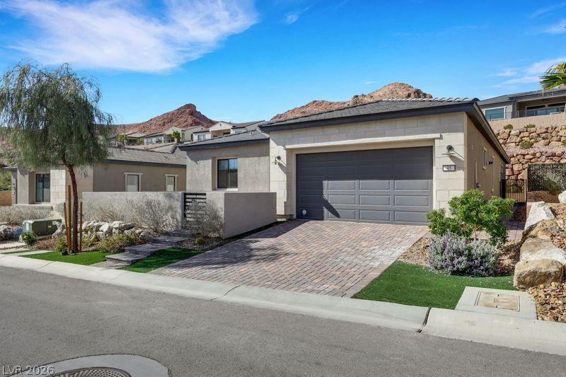 Image 1: A well-maintained paved driveway leads to a modern
