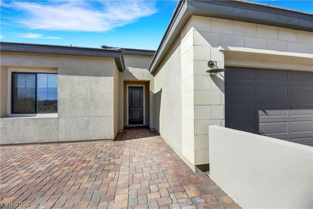 Image 3: A welcoming paver walkway leads to the sleek entra
