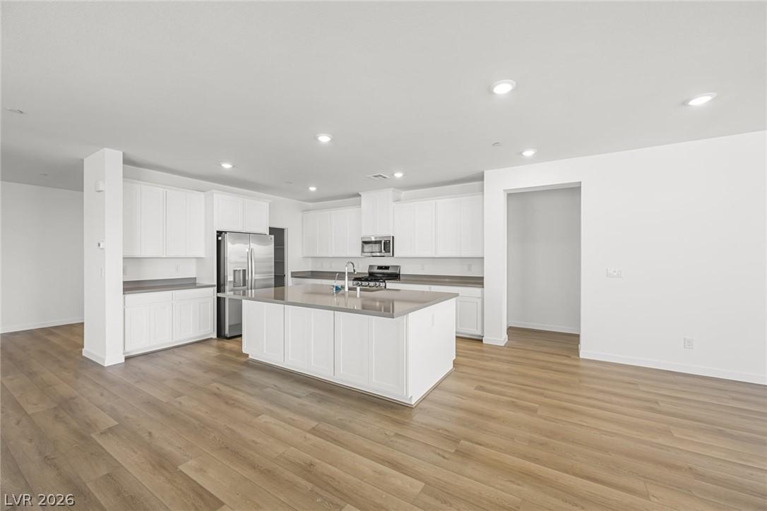 Image 4: An open-concept kitchen features a spacious island