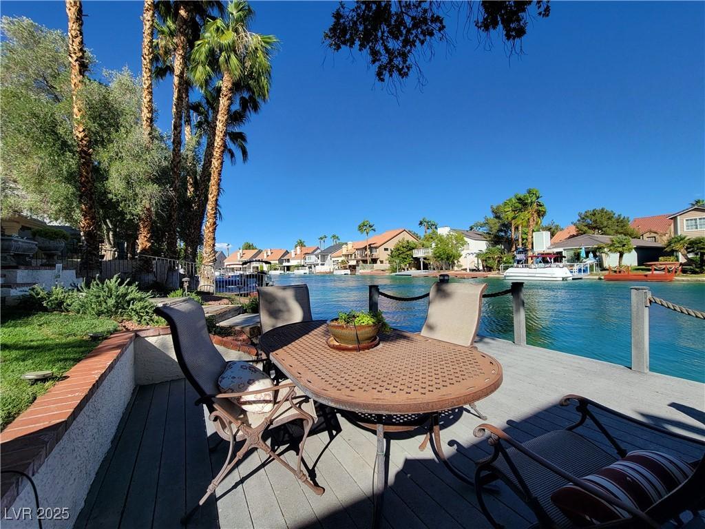 Image 3: Dock area with a residential view, a deck with wat