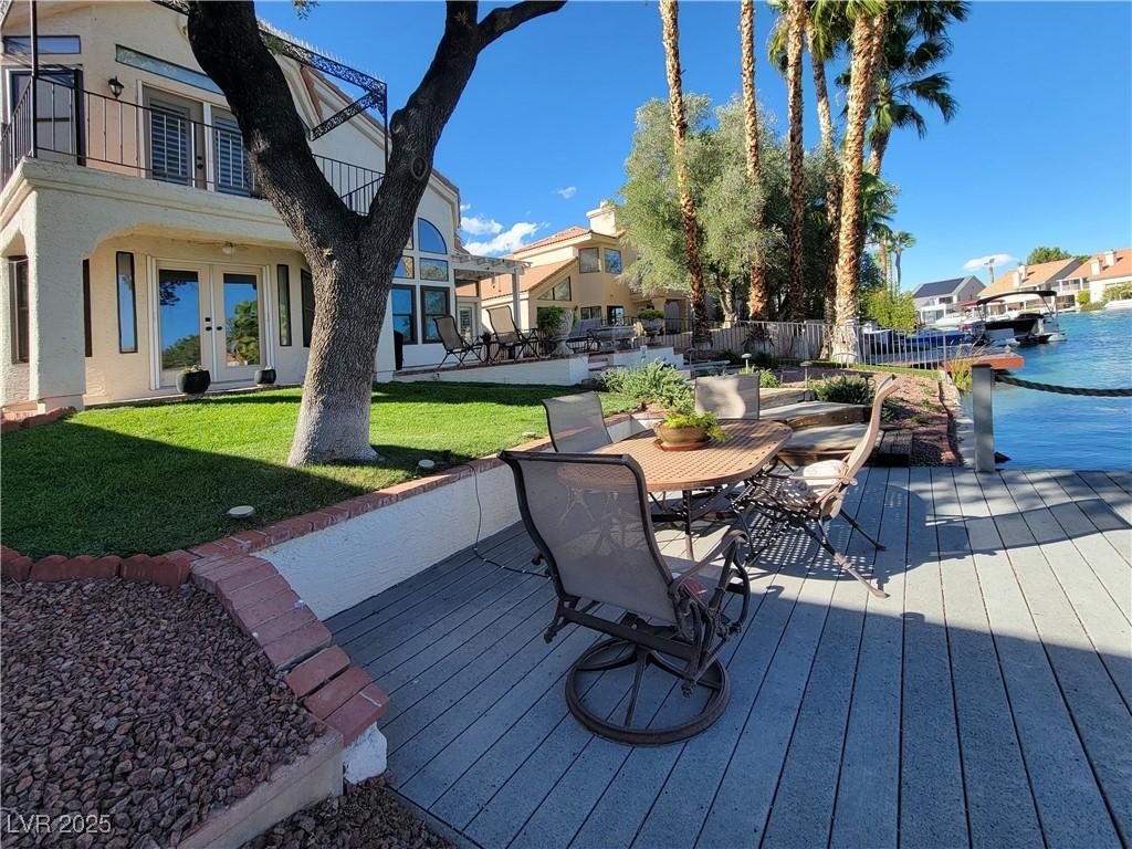 Image 4: Wooden deck with a patio area, a yard, outdoor din