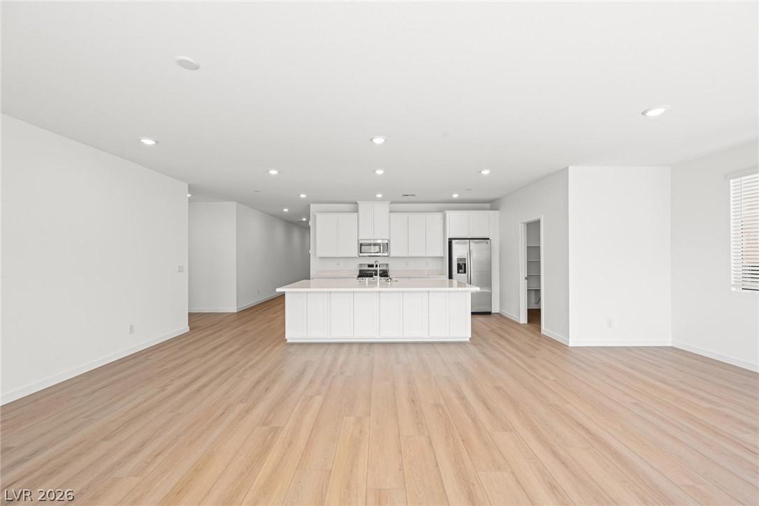Image 4: A pristine open-concept living area boasts a centr