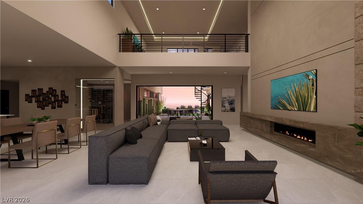 Image 4: An airy living area with soaring ceilings and a un