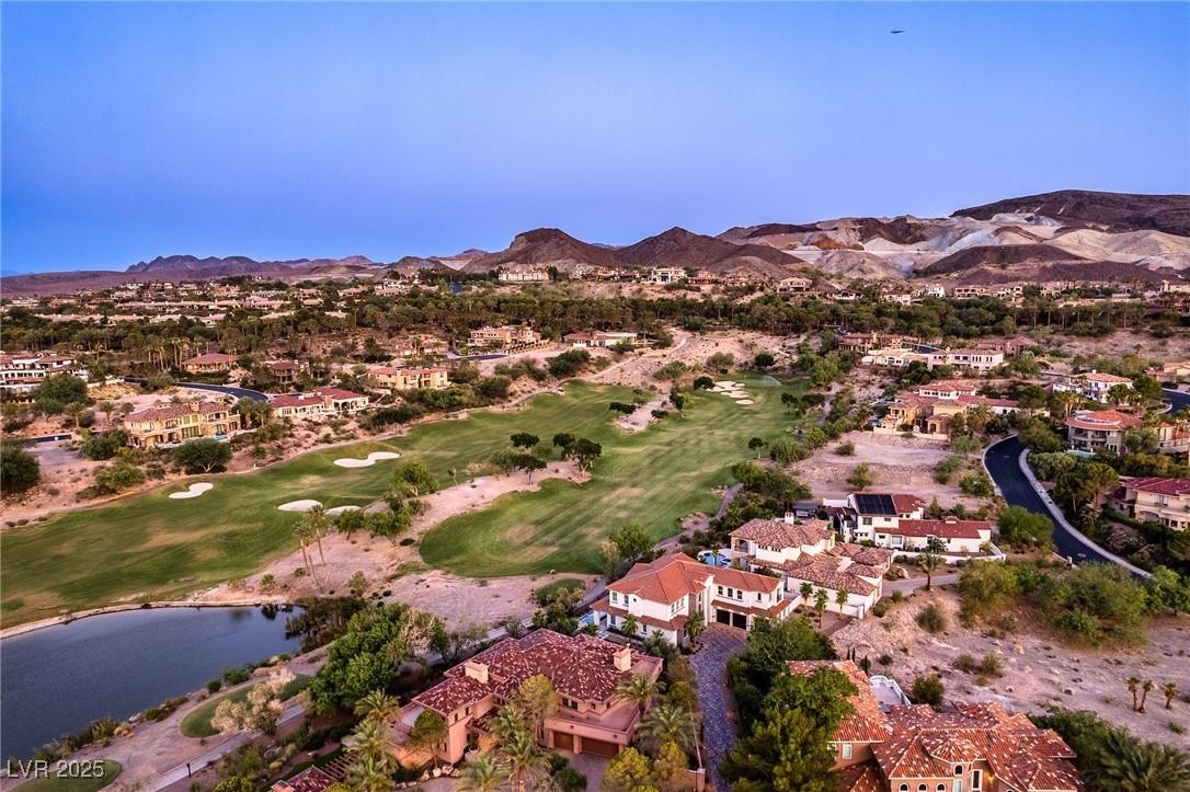 Image 2: Aerial view of residential area with a golf course