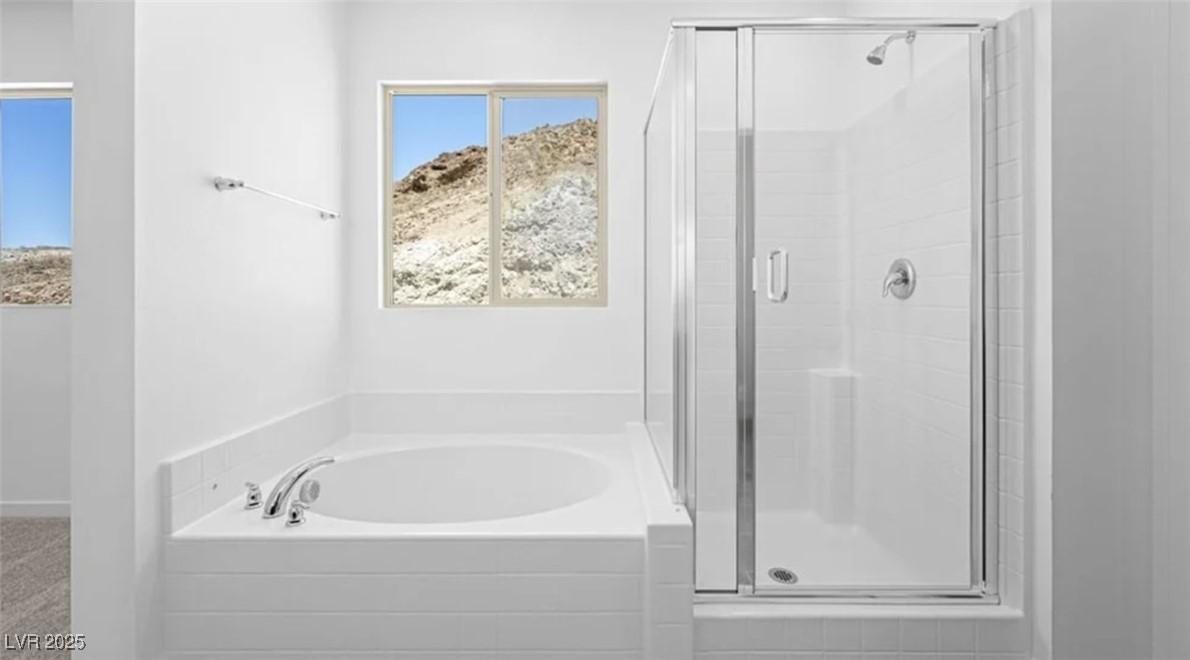 Image 4: Full bathroom featuring a shower stall and a bath