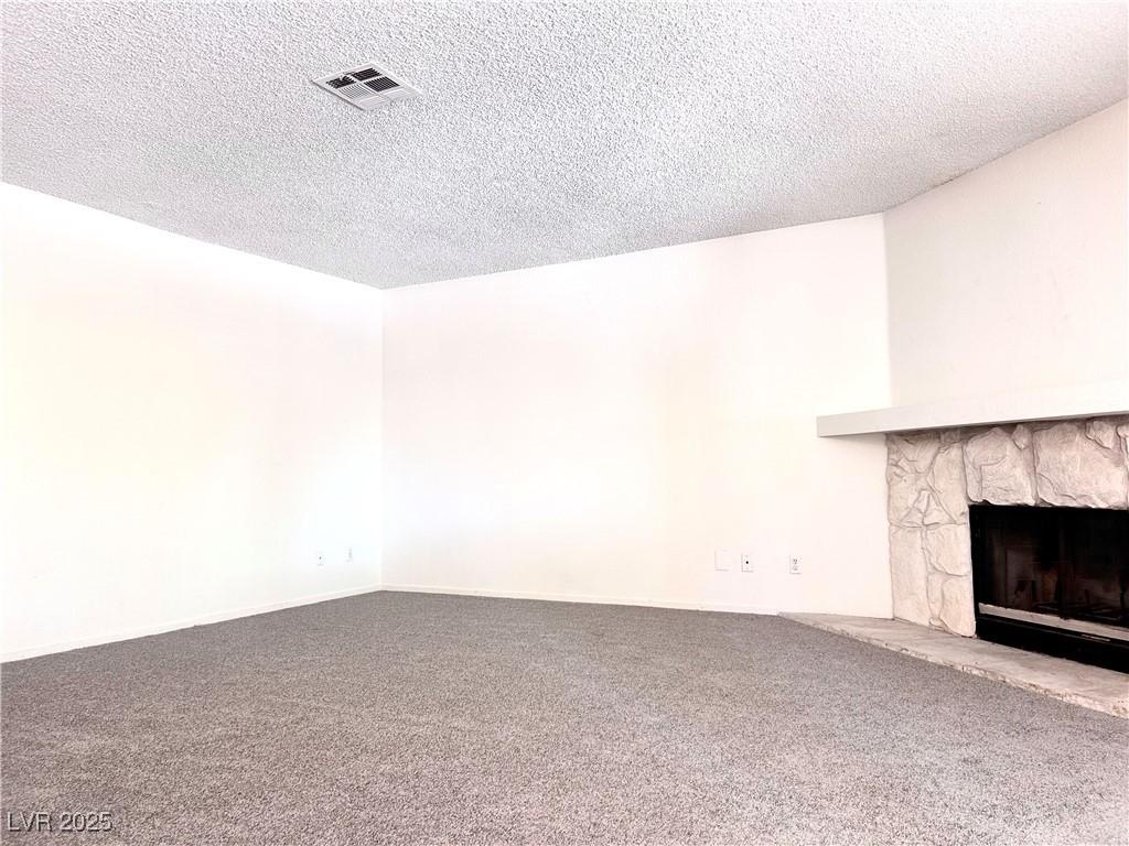 Image 4: Unfurnished living room featuring a fireplace, car