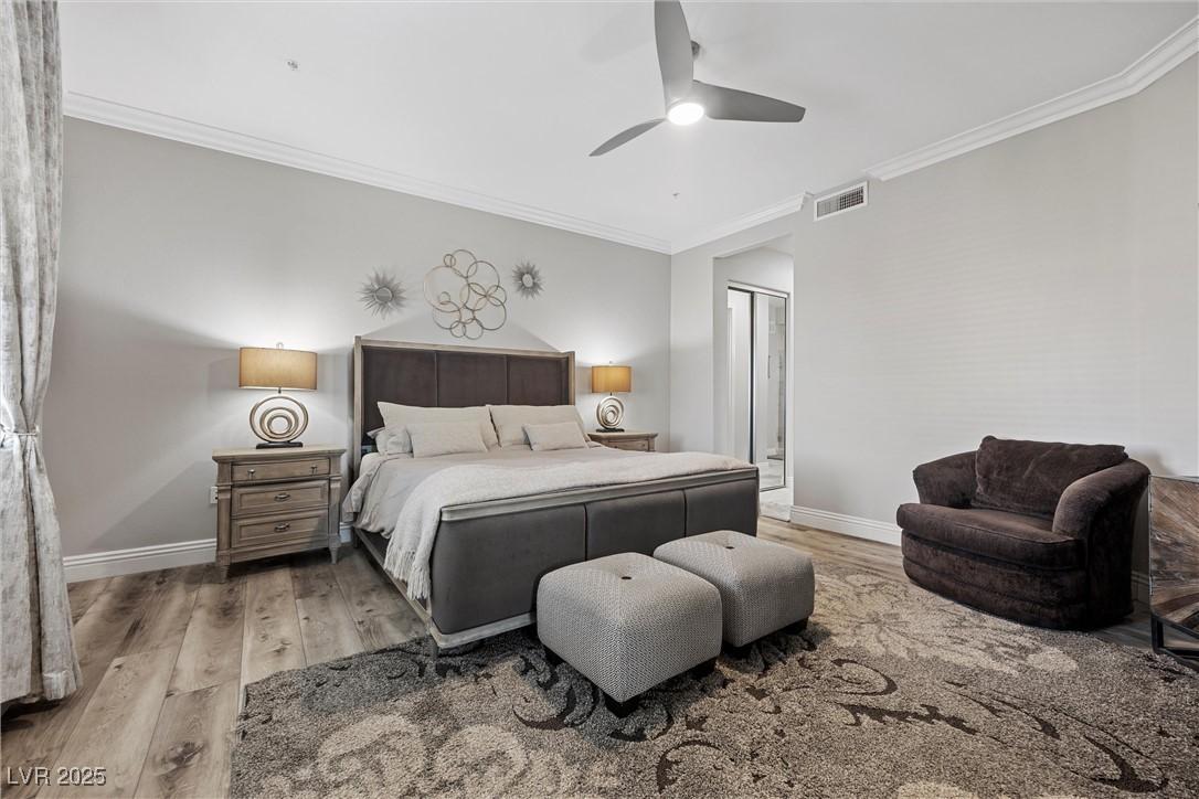 Image 4: Bedroom with wood finished floors, ornamental mold