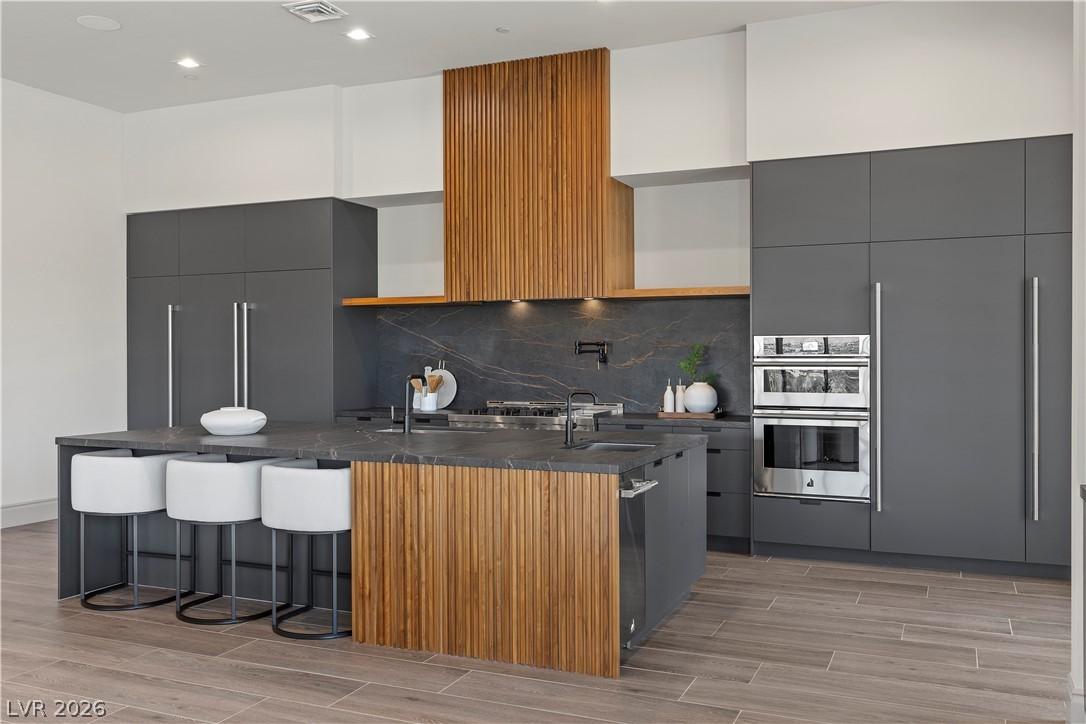 Image 4: Walnut accents with leathered quartz countertops