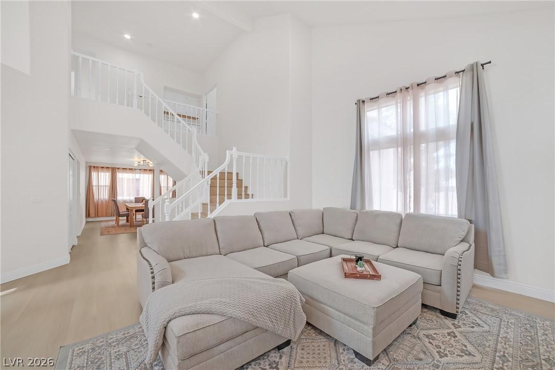 Image 4: Living area featuring wood finished floors and bas
