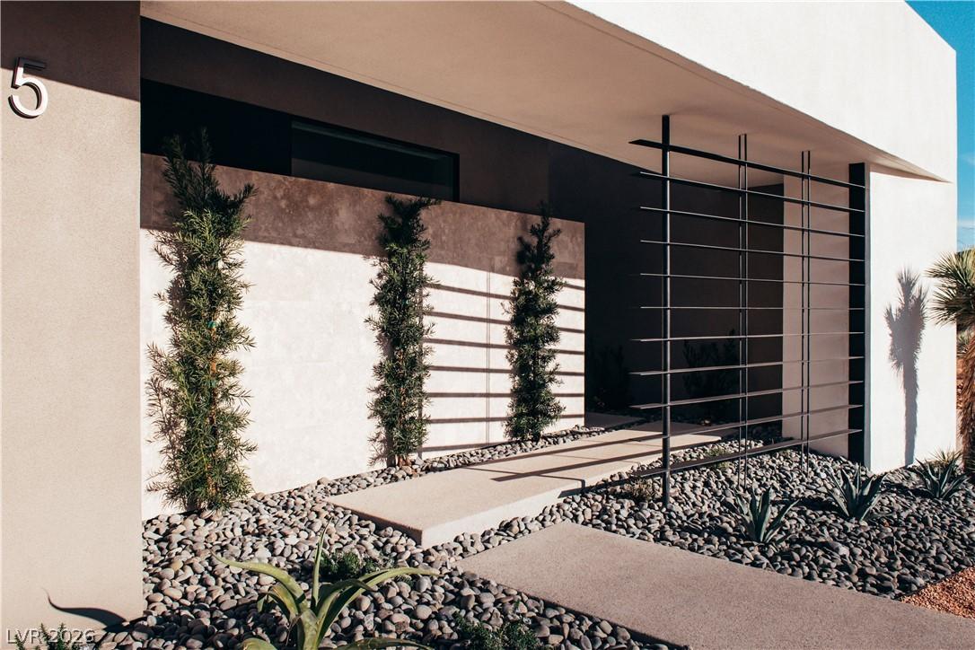 Image 3: Modern desert landscaping graces the facade, offer