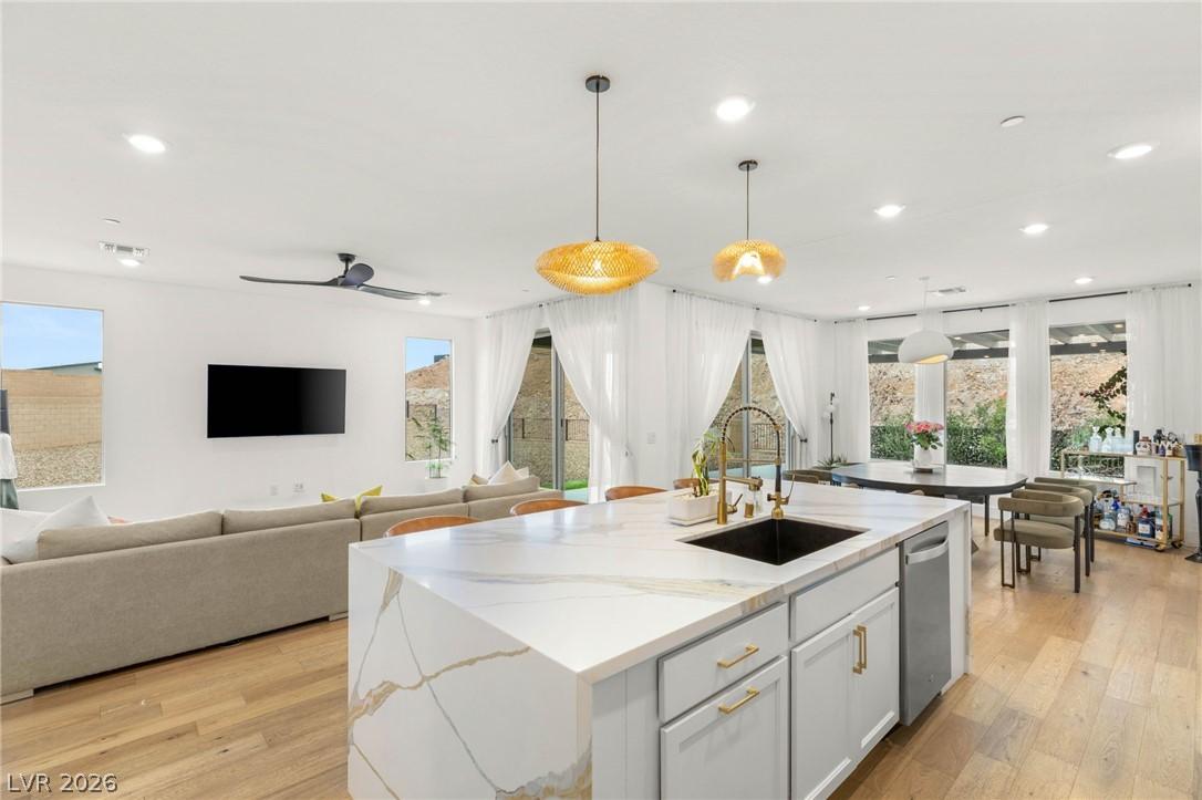 Image 1: This open concept living space features a modern k