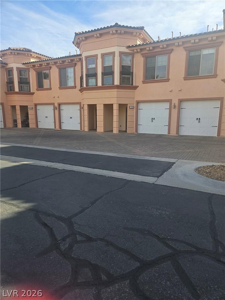 Image 1: Multi unit property featuring stucco siding, an at
