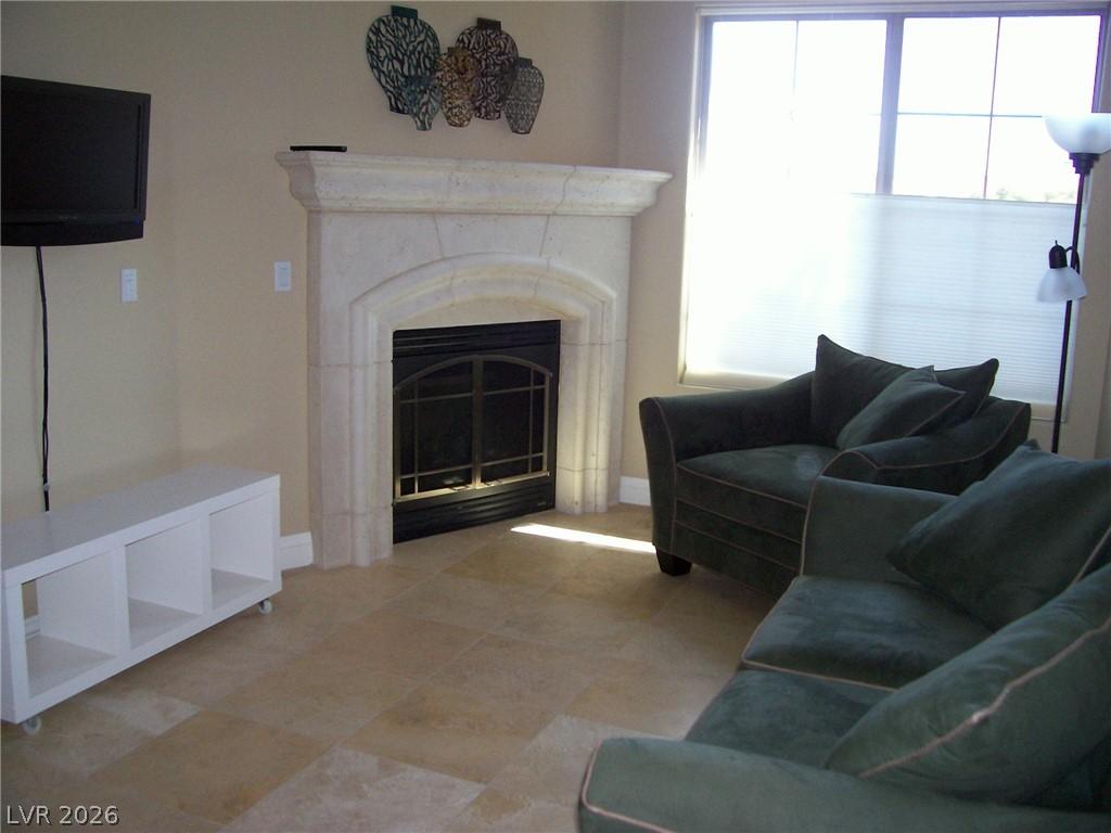 Image 2: Living room featuring baseboards and a glass cover