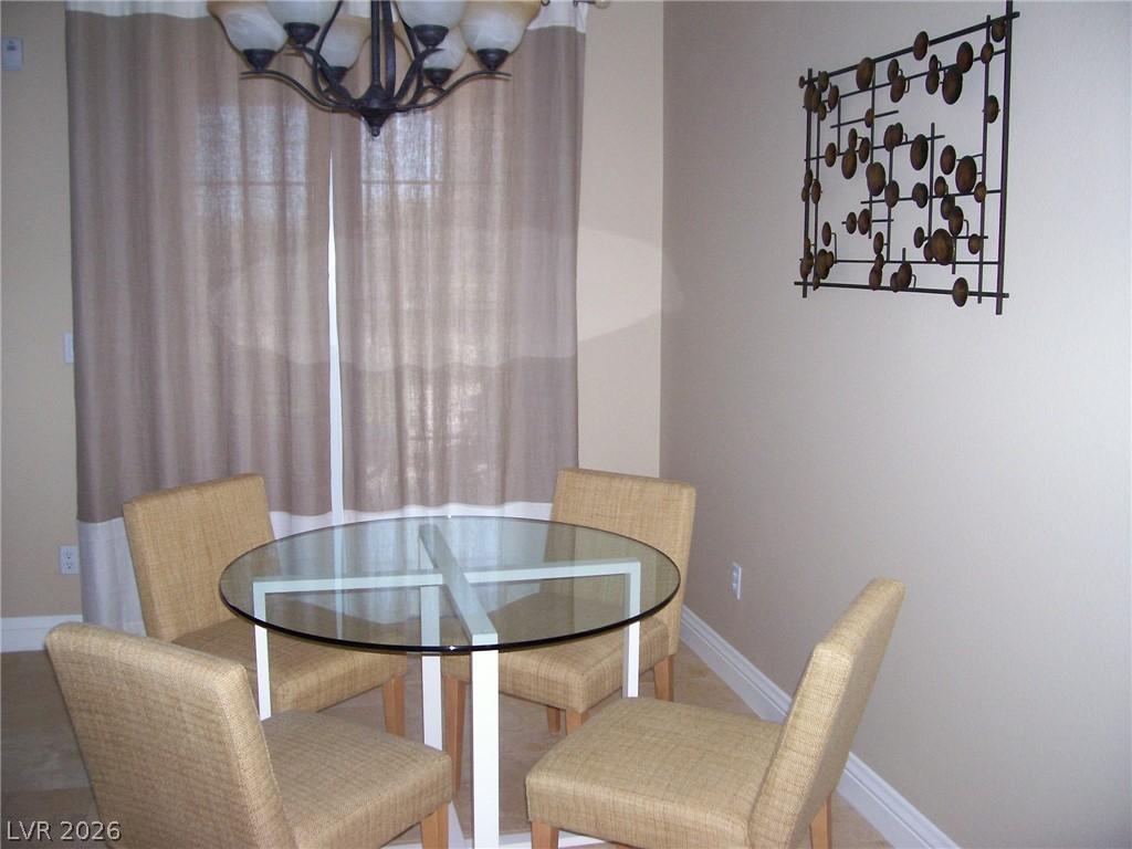 Image 3: Dining area featuring a chandelier and baseboards