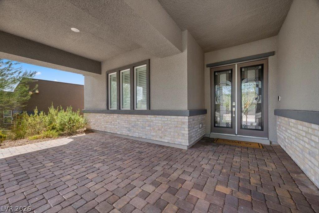 Image 3: A welcoming outside entry features decorative glas