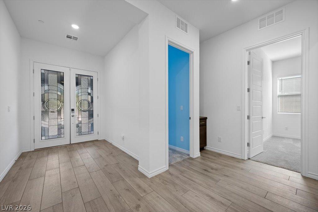 Image 4: A welcoming entryway boasts custom glass double do