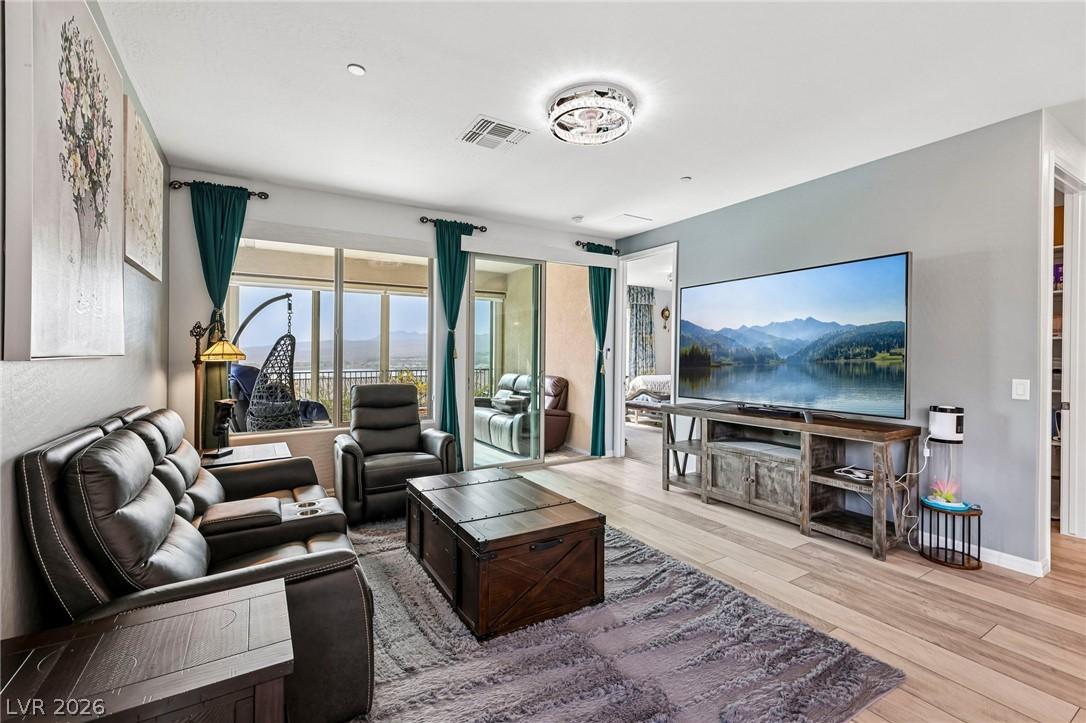 Image 3: A comfortable living space boasts large windows an