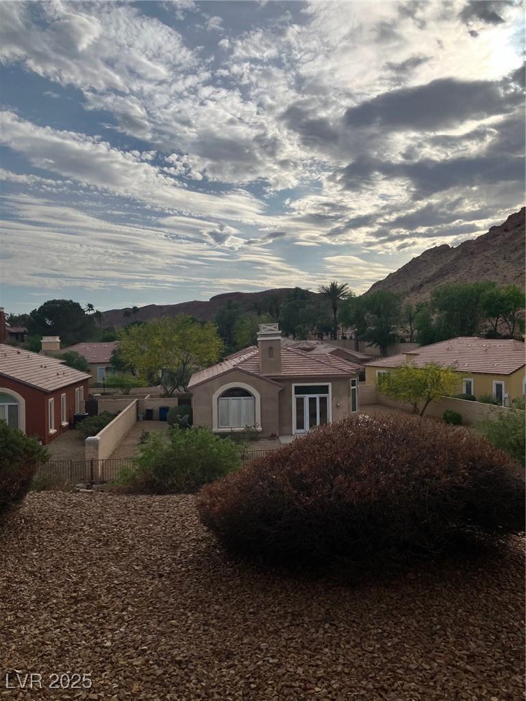 Image 4: View of home's exterior featuring fence, a mountai
