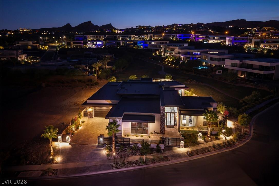 Image 2: Elegant exterior lighting illuminates this modern
