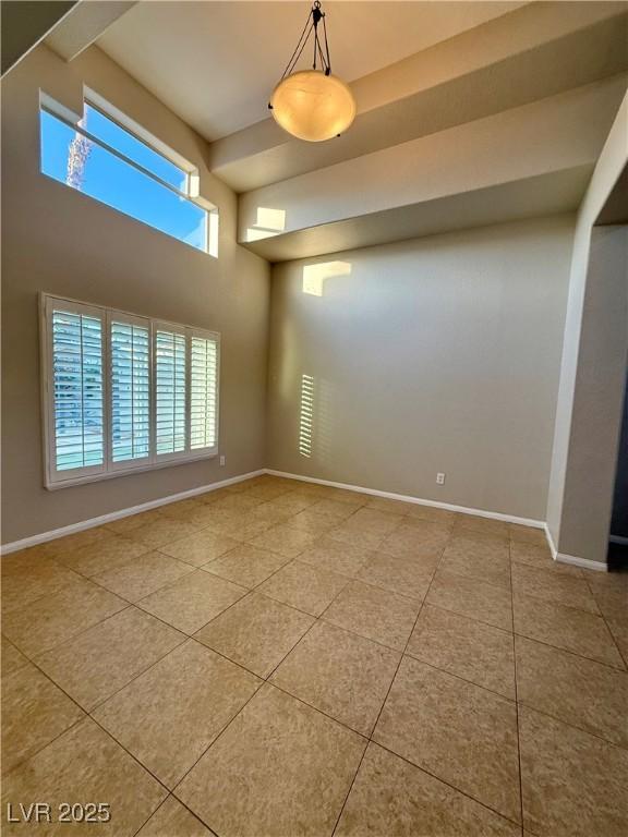 Image 4: Empty room featuring light tile patterned floors a