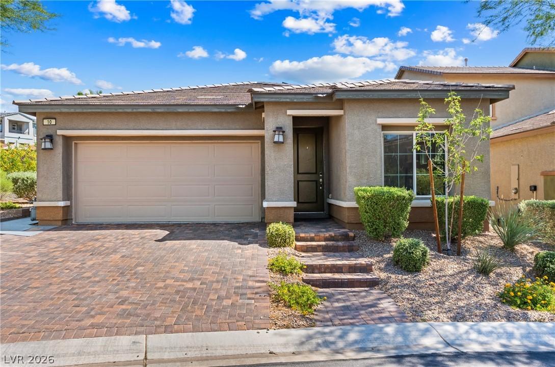 Image 4: This charming home features a paved driveway and i
