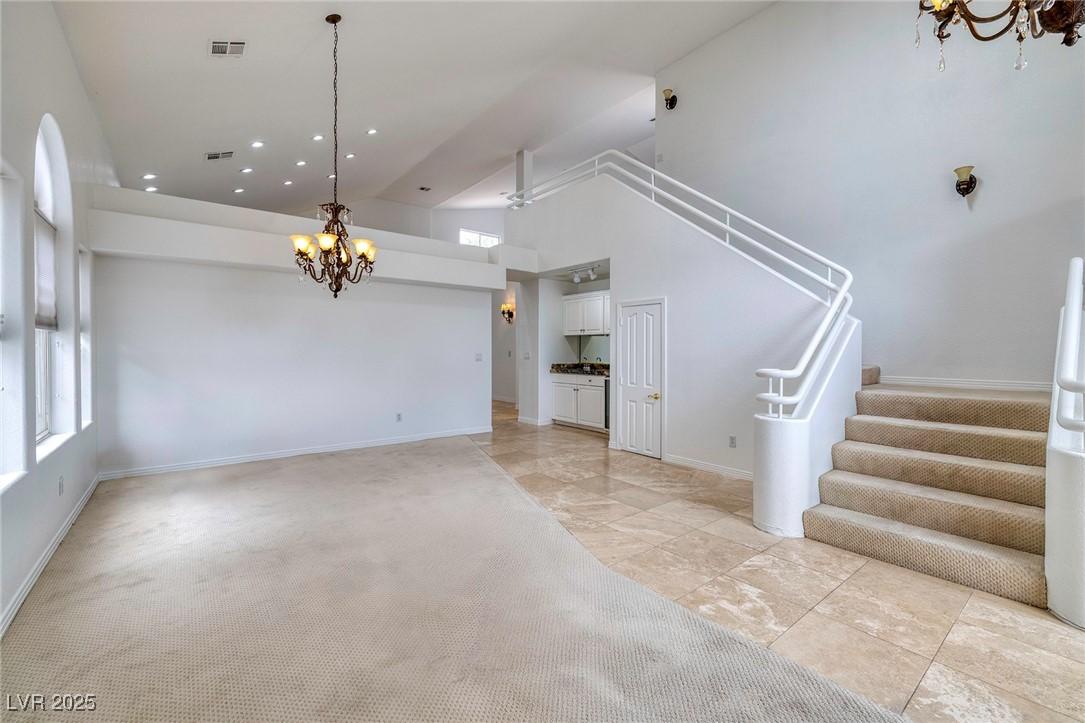 Image 4: Unfurnished living room featuring high vaulted cei