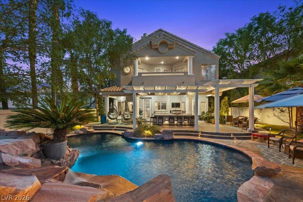 Image 1: An inviting backyard oasis features a freeform poo