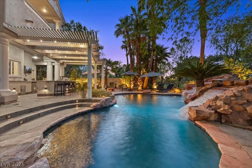 Image 2: An inviting backyard oasis offers a sparkling pool