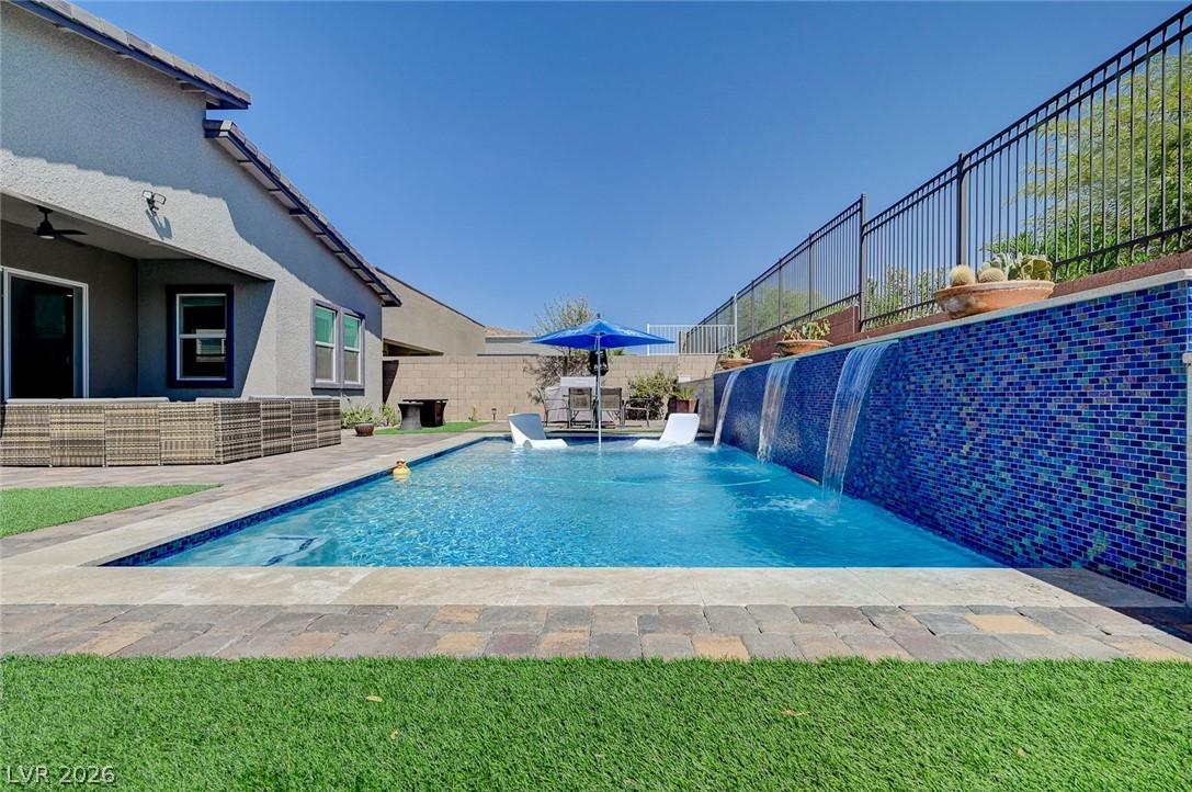 Image 2: This outdoor oasis features a refreshing pool with