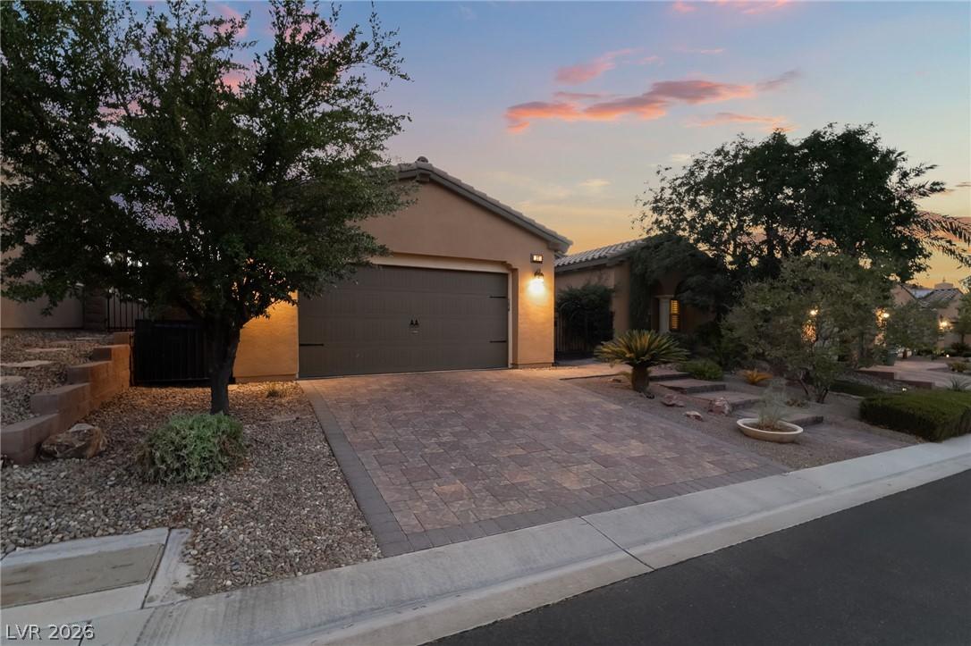 Image 2: A welcoming paver driveway leads to this charming