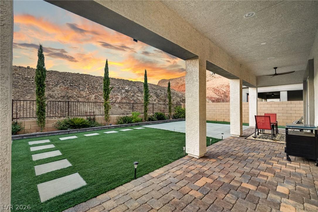 Image 2: An inviting covered patio with brick pavers offers