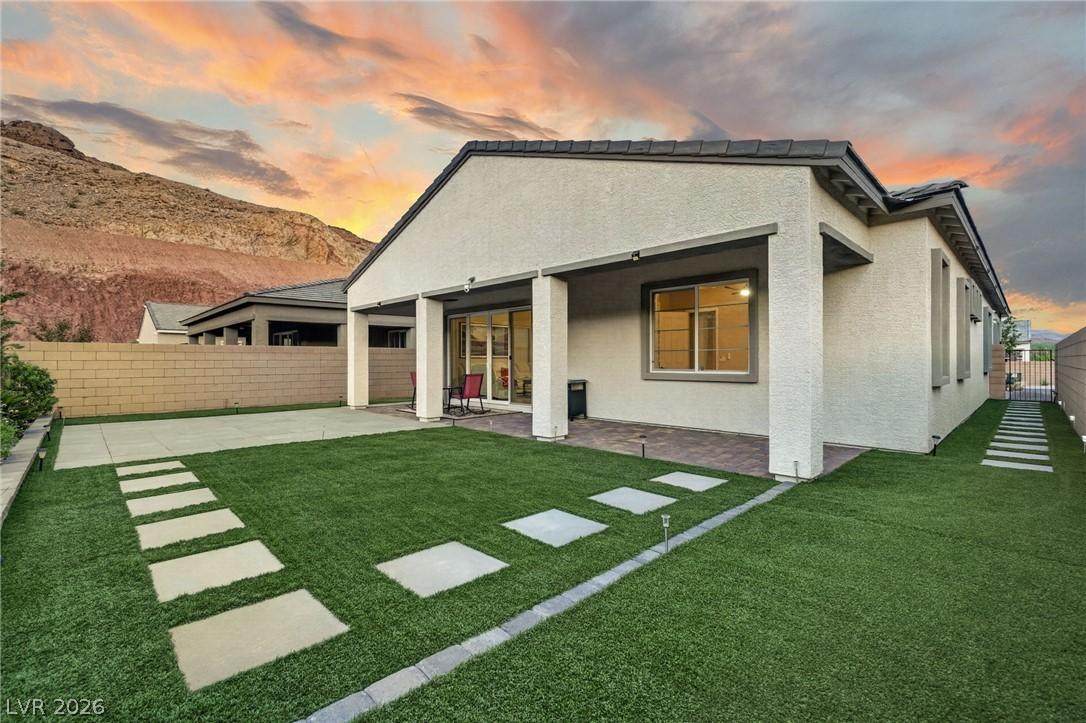 Image 3: A private yard with artificial turf and a covered