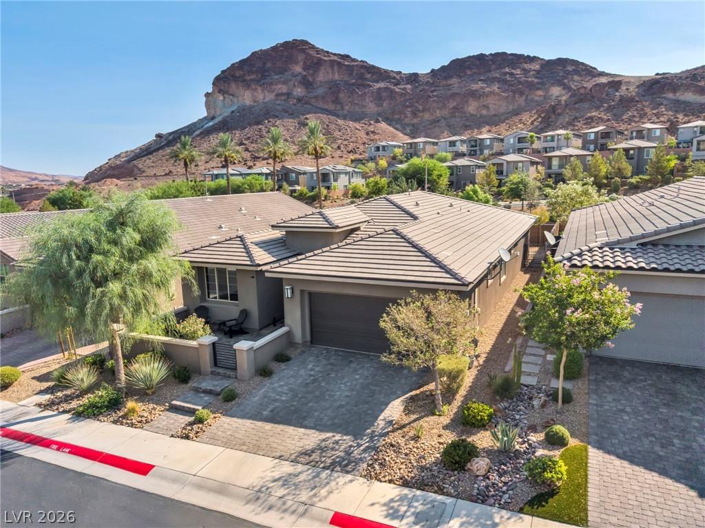 Image 2: A desert oasis with a paved driveway and mountain