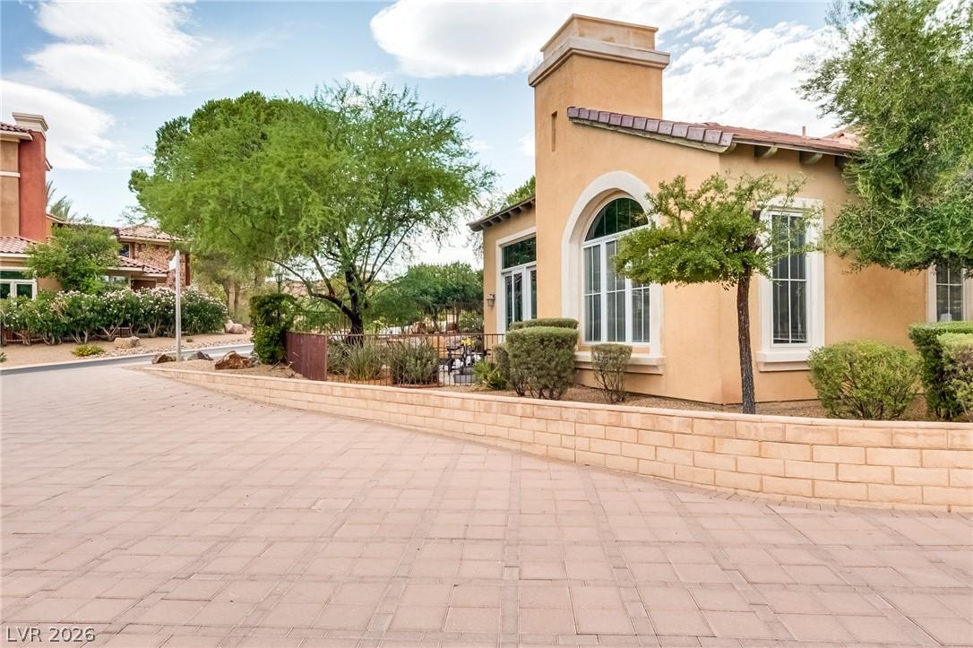 Image 4: Ornate arched windows complement the stucco exteri