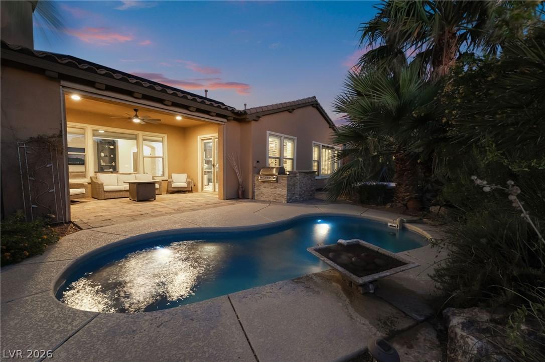 Image 4: An inviting backyard oasis offers a sparkling pool
