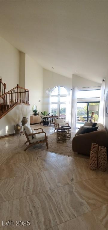 Image 4: Living room featuring a chandelier, stairway, and