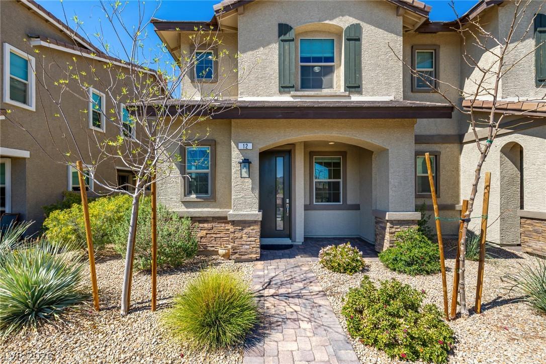 Image 1: A welcoming front entrance features a paver walkwa