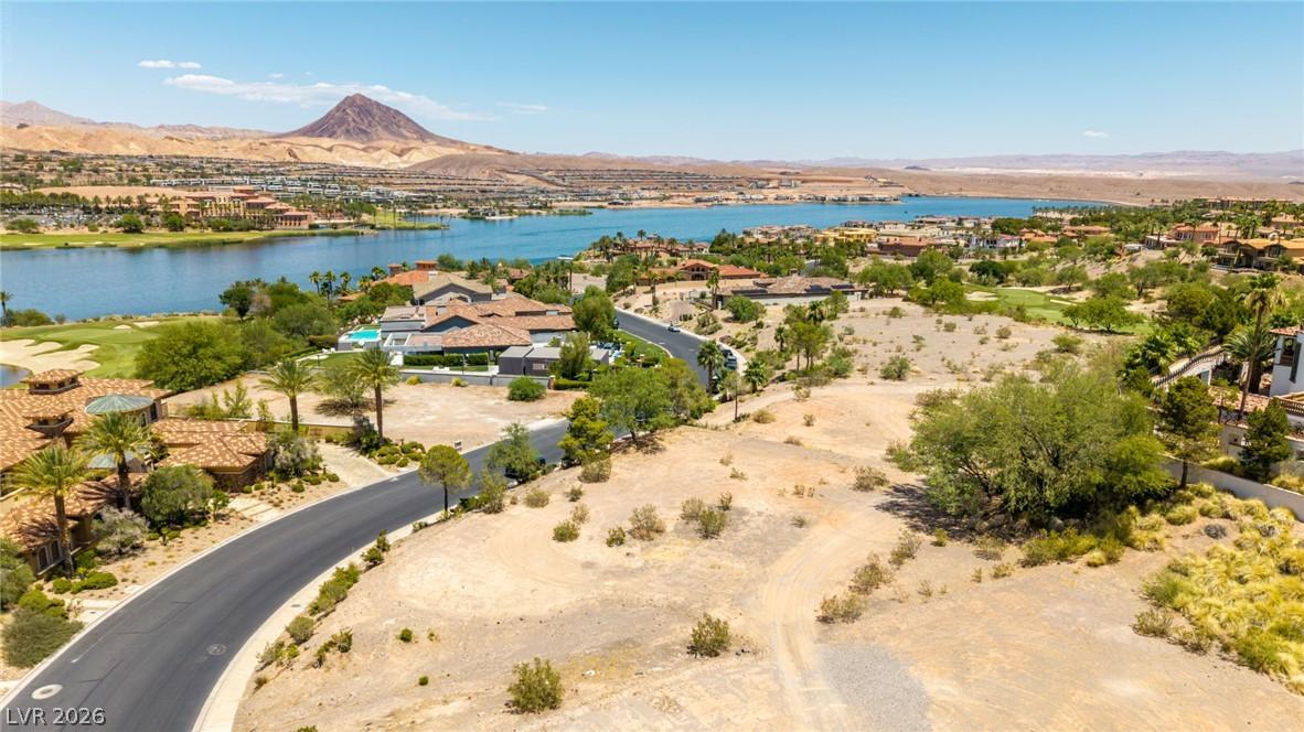 Image 2: A winding road leads to luxurious homes, nestled a