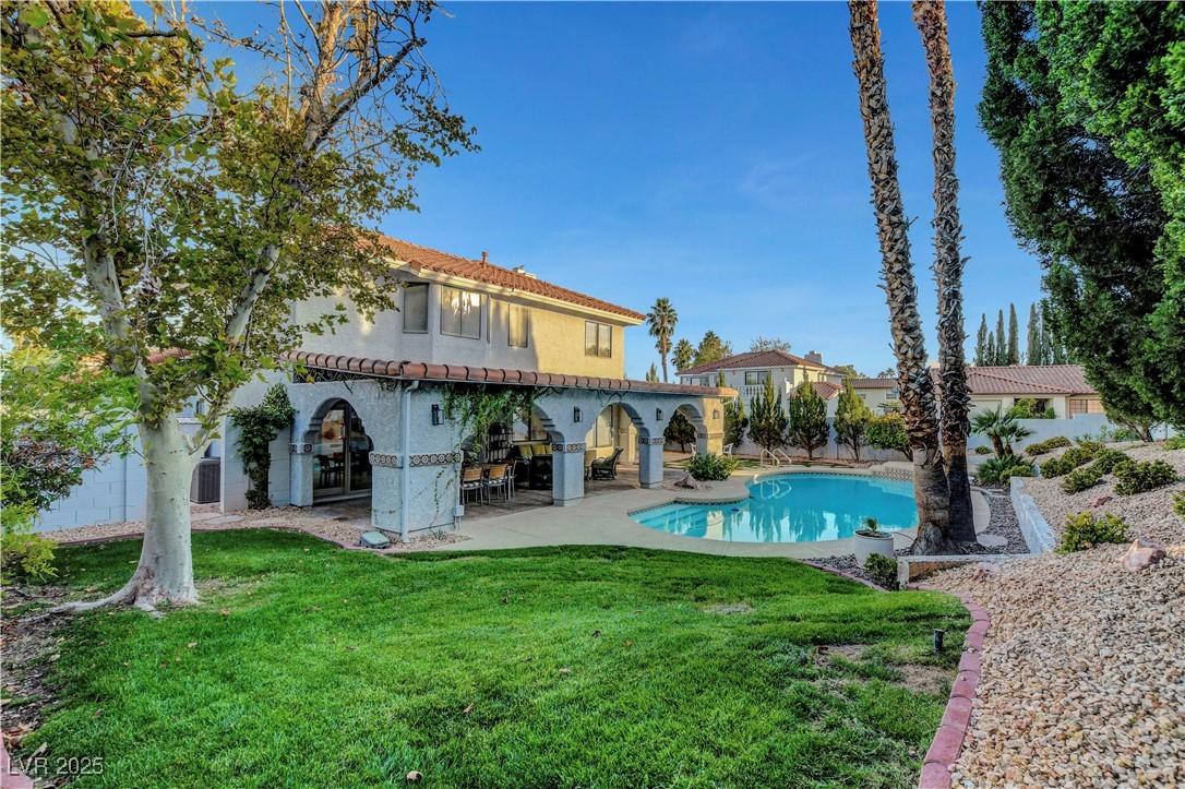 Image 2: Back of house featuring a tile roof, a patio area,