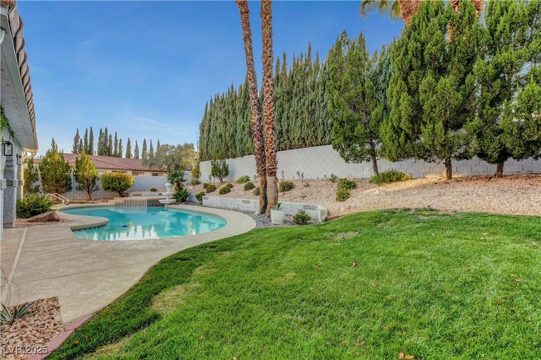 Image 3: View of pool with a fenced backyard and a patio ar