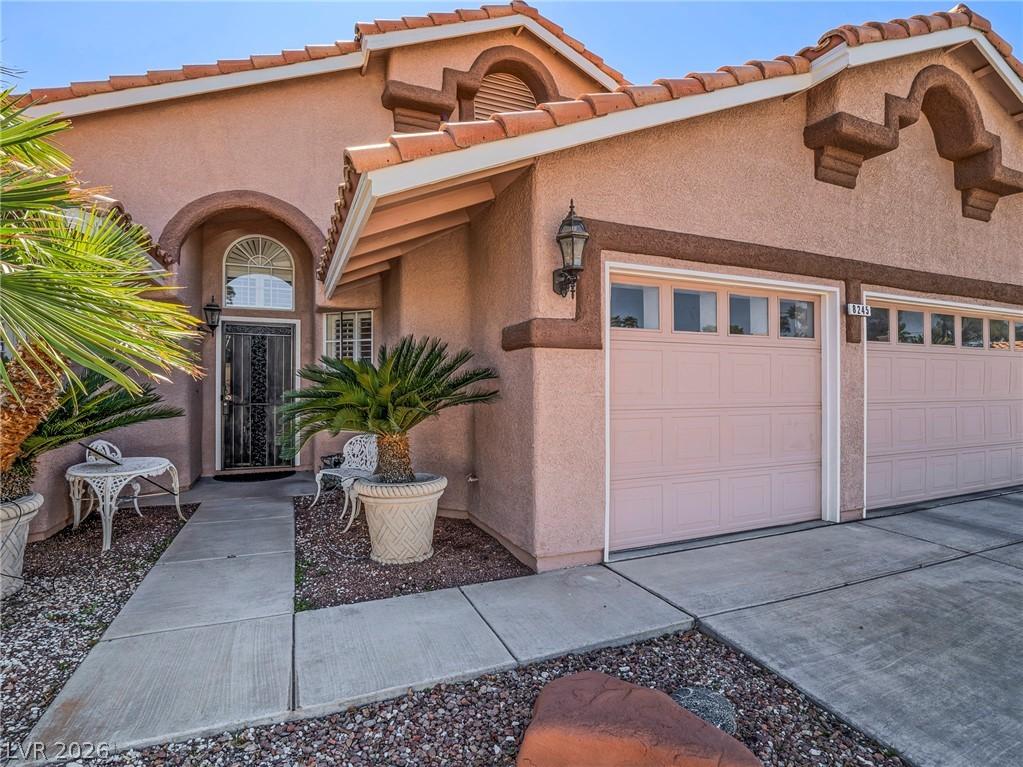 Image 4: View of front of house with an attached garage, st